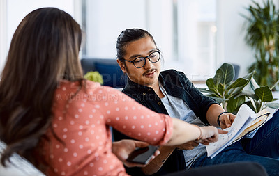Buy stock photo Shot of a young businessman and businesswoman having a meeting in a modern office