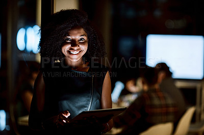 Buy stock photo Shot of a young businesswoman using a digital tablet during a late night at work