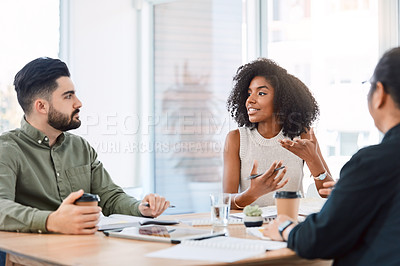 Buy stock photo Shot of a group of young businesspeople having a meeting in a modern office