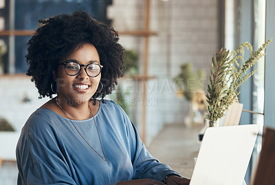 Buy stock photo Portrait of an attractive young businesswoman sitting and working on her laptop in a coffee shop during the day