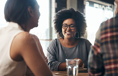 Buy stock photo Shot of a happy young diverse group sitting together in a coffee shop during the day