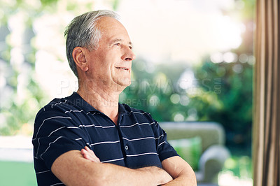 Buy stock photo Shot of a confident senior man looking thoughtful in his home