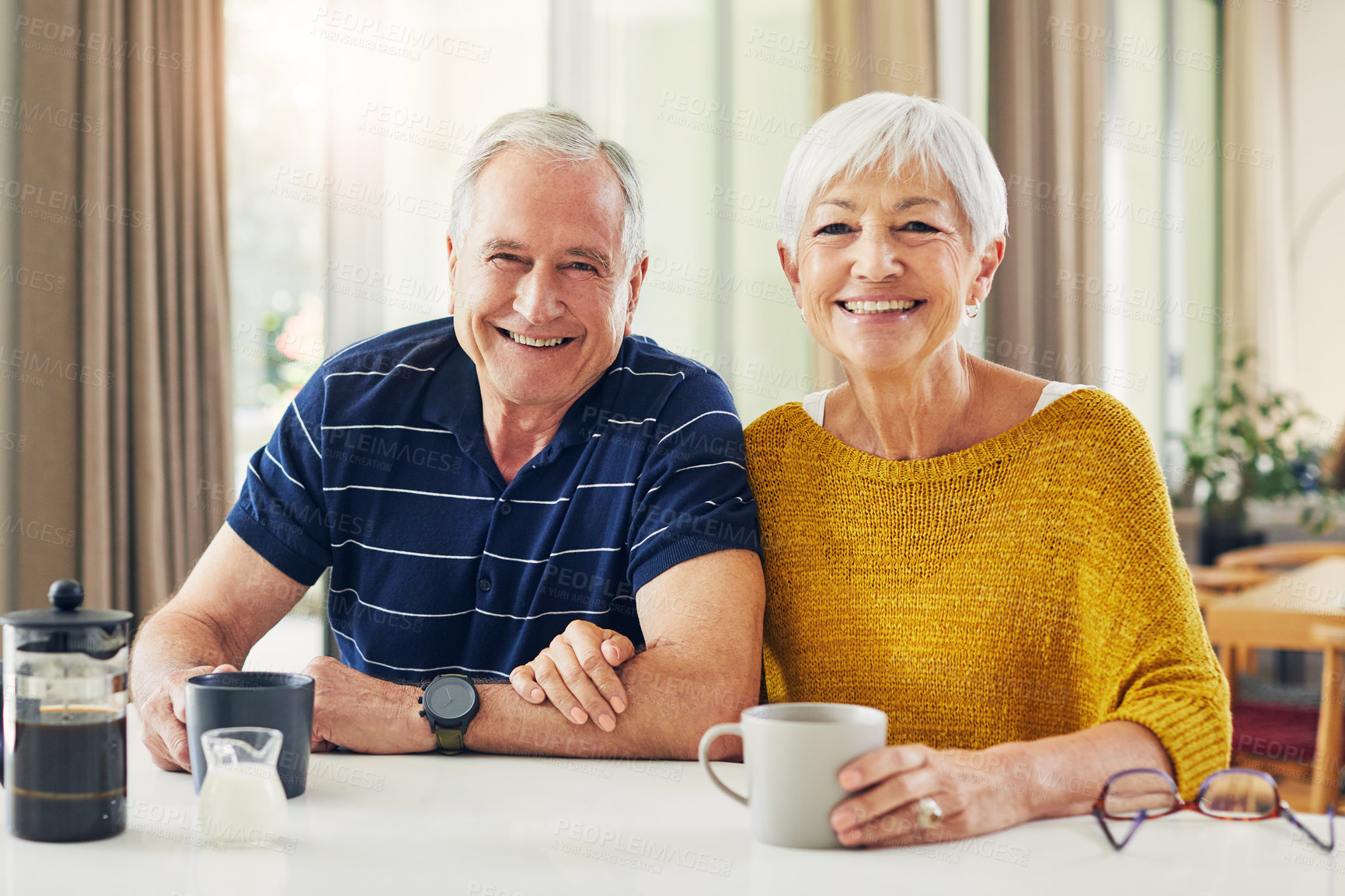 Buy stock photo Shot of a senior couple enjoying a coffee break at home