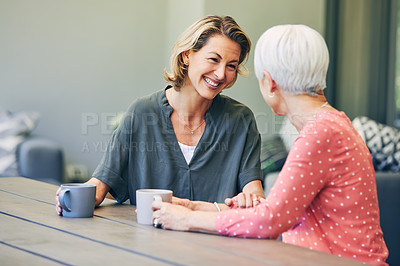 Buy stock photo Shot of a mature woman and her elderly mother having coffee and a chat at home