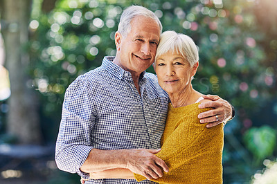 Buy stock photo Shot of a happy senior couple embracing outdoors
