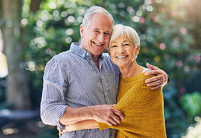 Buy stock photo Shot of a happy senior couple embracing outdoors