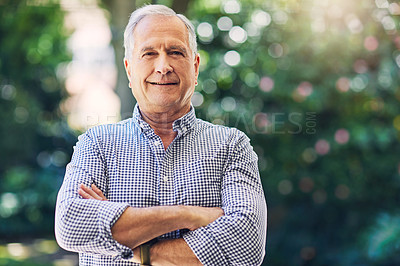 Buy stock photo Shot of a happy senior man standing outdoors