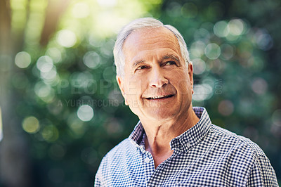Buy stock photo Shot of a confident senior man looking thoughtful outdoors