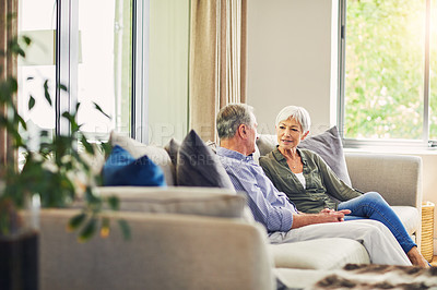 Buy stock photo Shot of a happy senior couple relaxing together on the sofa at home