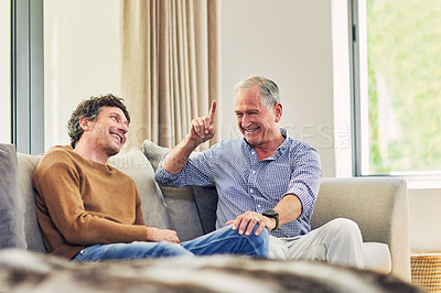 Buy stock photo Shot of a mature man and his elderly father sitting on the sofa at home and chatting