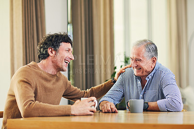 Buy stock photo Shot of a mature man and his elderly father having coffee and a chat at home