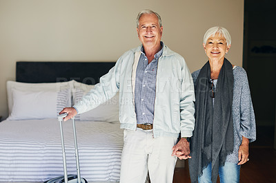 Buy stock photo Shot of a happy senior couple standing in their hotel room