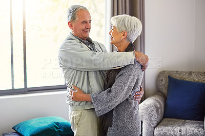 Buy stock photo Shot of a happy senior couple embracing in their hotel room