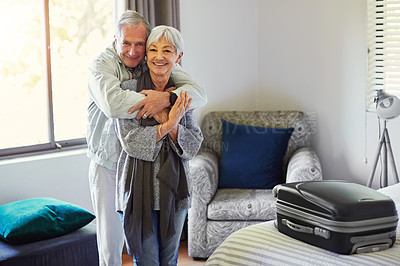 Buy stock photo Shot of a happy senior couple embracing in their hotel room