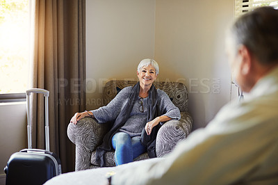 Buy stock photo Shot of a happy senior couple relaxing in their hotel room