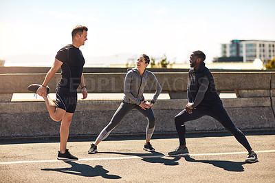 Buy stock photo Shot of a group of sporty young people out exercising together