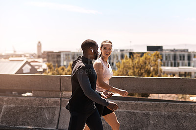 Buy stock photo Shot of two sporty young people out for a run