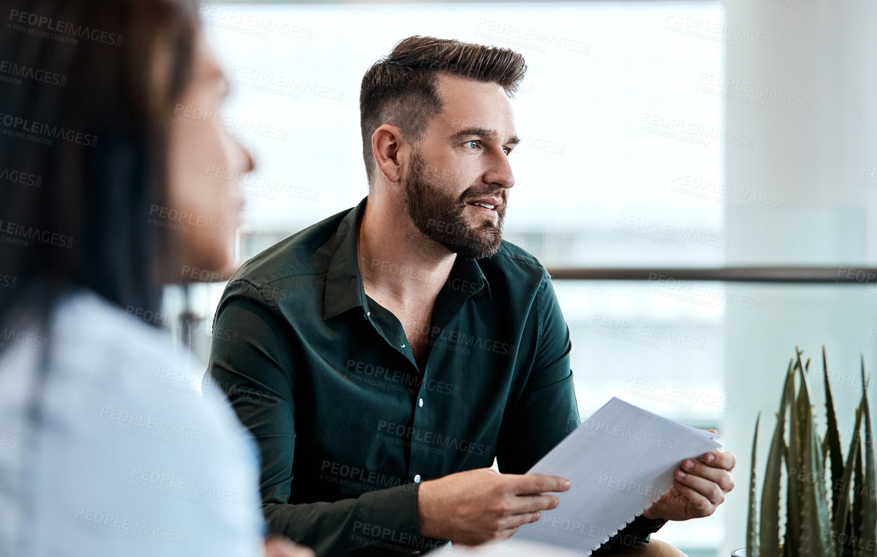 Buy stock photo Cropped shot of two business colleagues sitting down during a meeting in their office