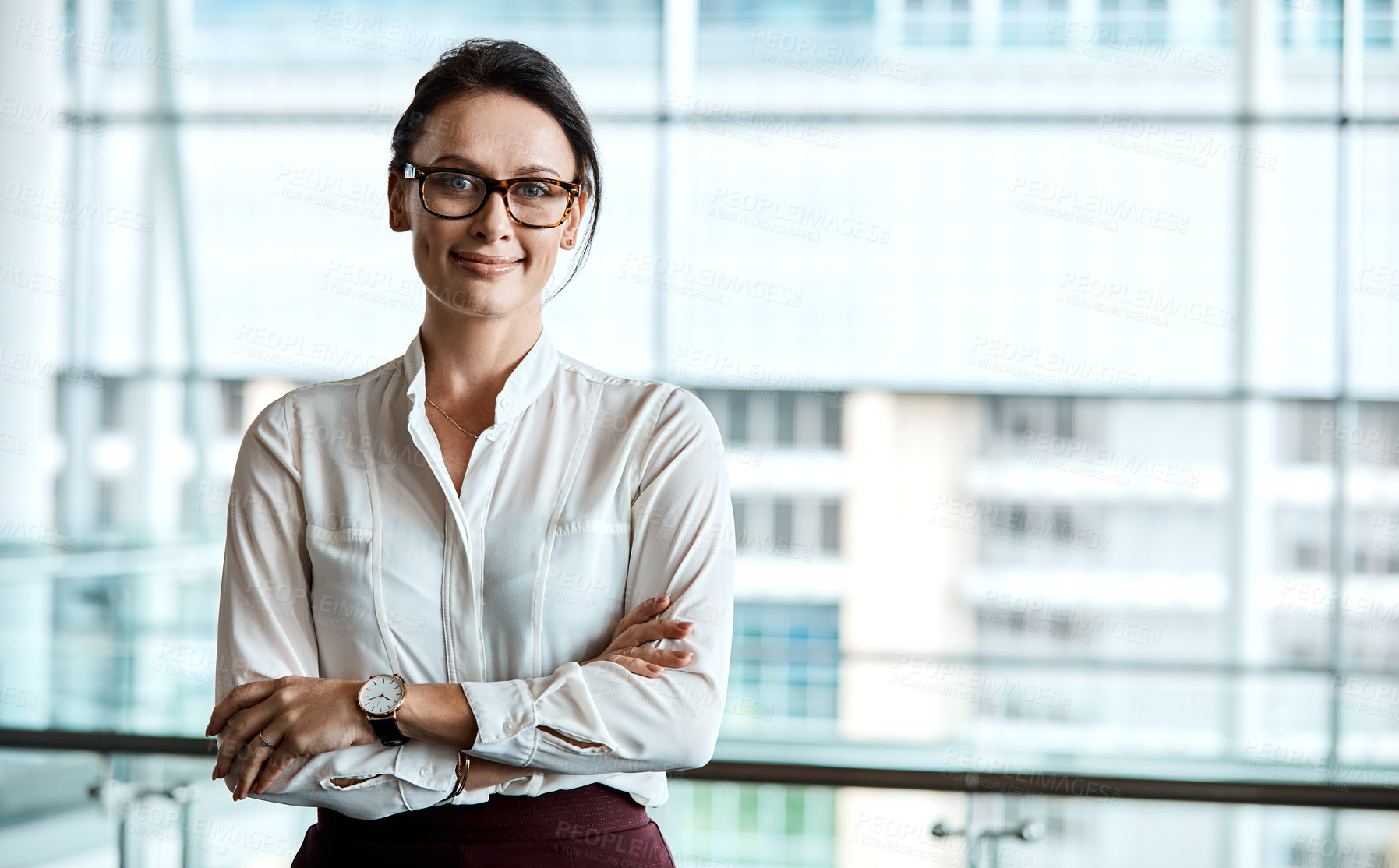 Buy stock photo Cropped portrait of an attractive businesswoman standing with her arms folded in the office