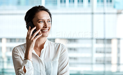 Buy stock photo Cropped shot of an attractive businesswoman making a phonecall while standing in her office