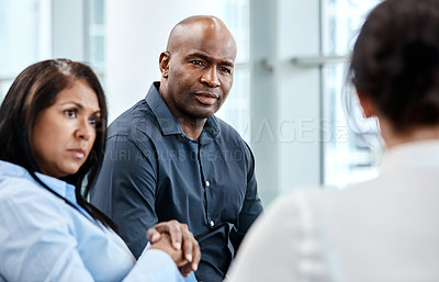 Buy stock photo Cropped shot of three business colleagues having a discussion while sitting in their office