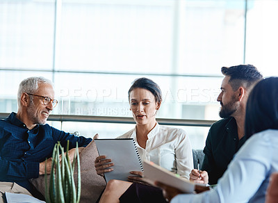 Buy stock photo Shot of a group of businesspeople having a meeting together at work