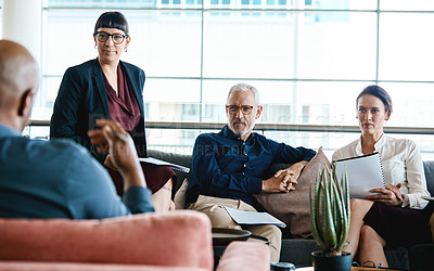 Buy stock photo Shot of a group of businesspeople having a meeting together at work