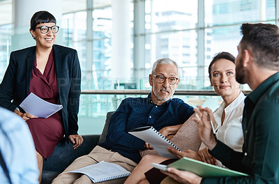 Buy stock photo Shot of a group of businesspeople having a meeting together at work