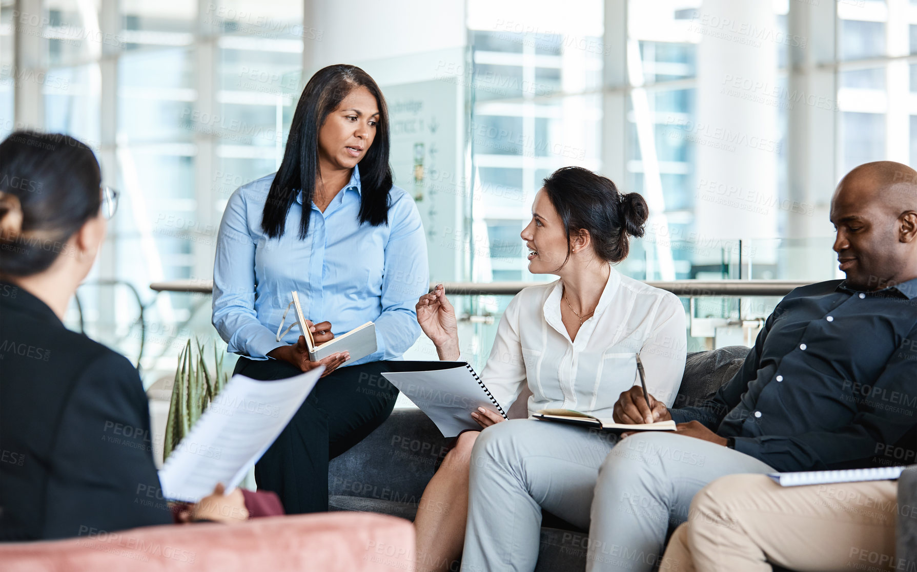 Buy stock photo Shot of a group of businesspeople having a meeting together at work