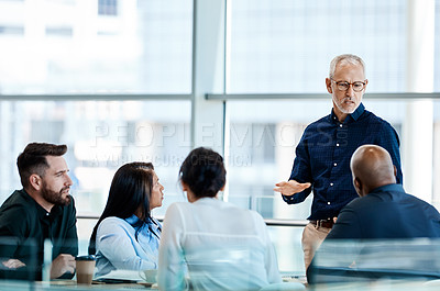 Buy stock photo Shot of a group of businesspeople during a boardroom meeting at work