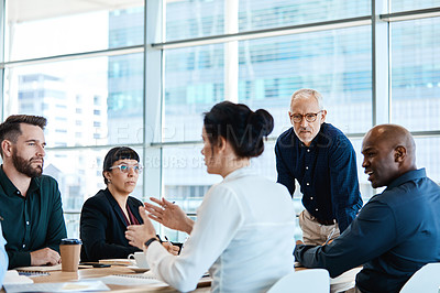 Buy stock photo Shot of a group of businesspeople during a boardroom meeting at work