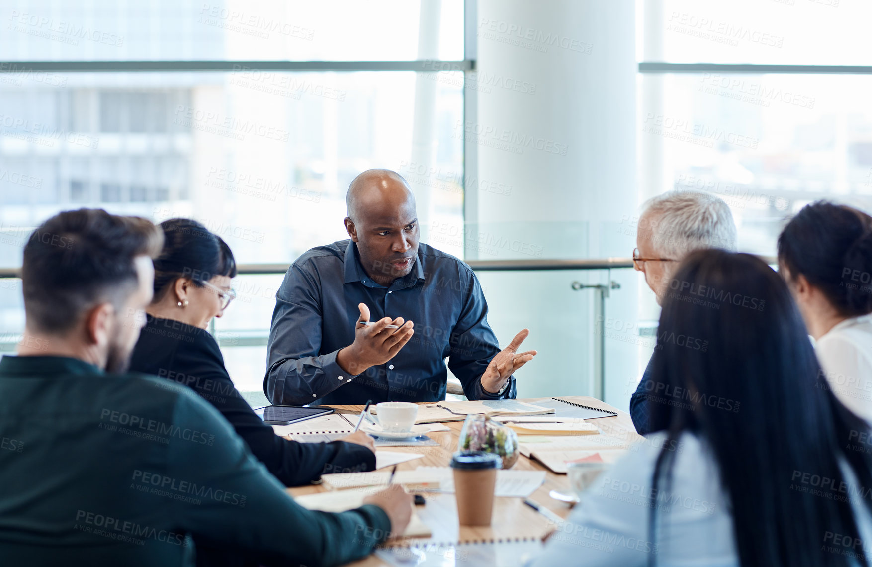 Buy stock photo Shot of a group of businesspeople during a boardroom meeting at work