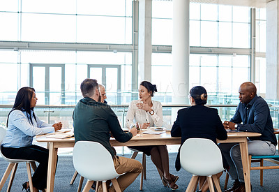 Buy stock photo Full length shot of a group of businesspeople during a boardroom meeting at work