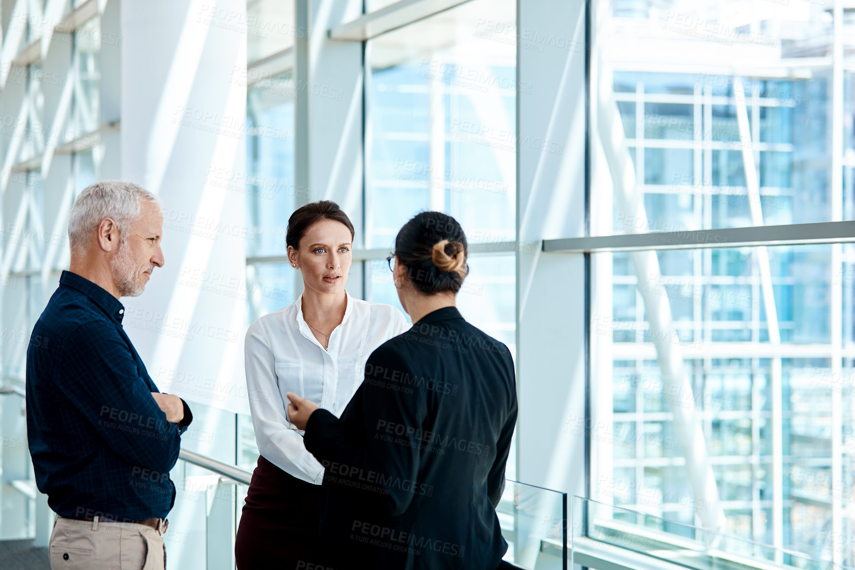 Buy stock photo Shot of a group of businesspeople having a discussion together at work