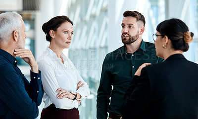 Buy stock photo Shot of a group of businesspeople having a discussion together at work