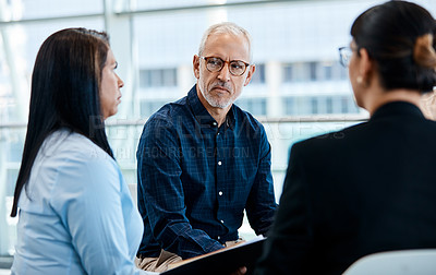 Buy stock photo Shot of a group of businesspeople during a meeting at work