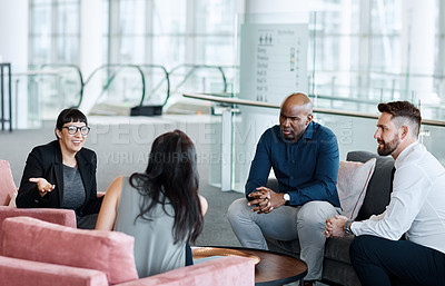 Buy stock photo Shot of a group of businesspeople having a meeting together at work