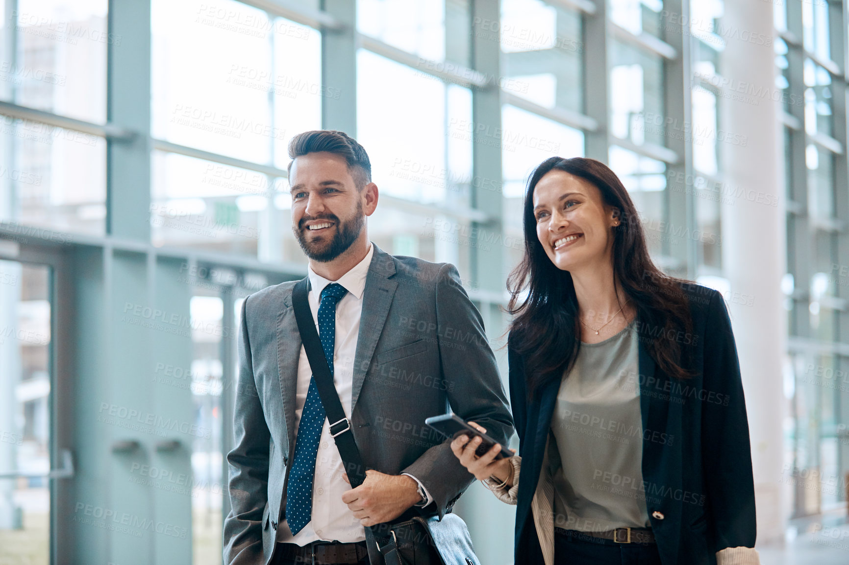 Buy stock photo Business people, laugh and team with phone for travel, work trip and partnership in airport. Employee, terminal lobby and tech for international opportunity, social media or project collaboration