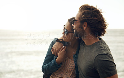Buy stock photo Cropped shot of an affectionate young couple holding each other on the beach during a road trip