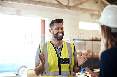 Buy stock photo Cropped shot of a handsome young male warehouse worker talking to his supervisor