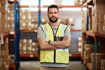 Buy stock photo Cropped portrait of a handsome young male warehouse worker standing with his arms crossed