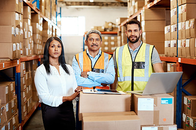 Buy stock photo Cropped portrait of three warehouse workers checking on distribution logistics