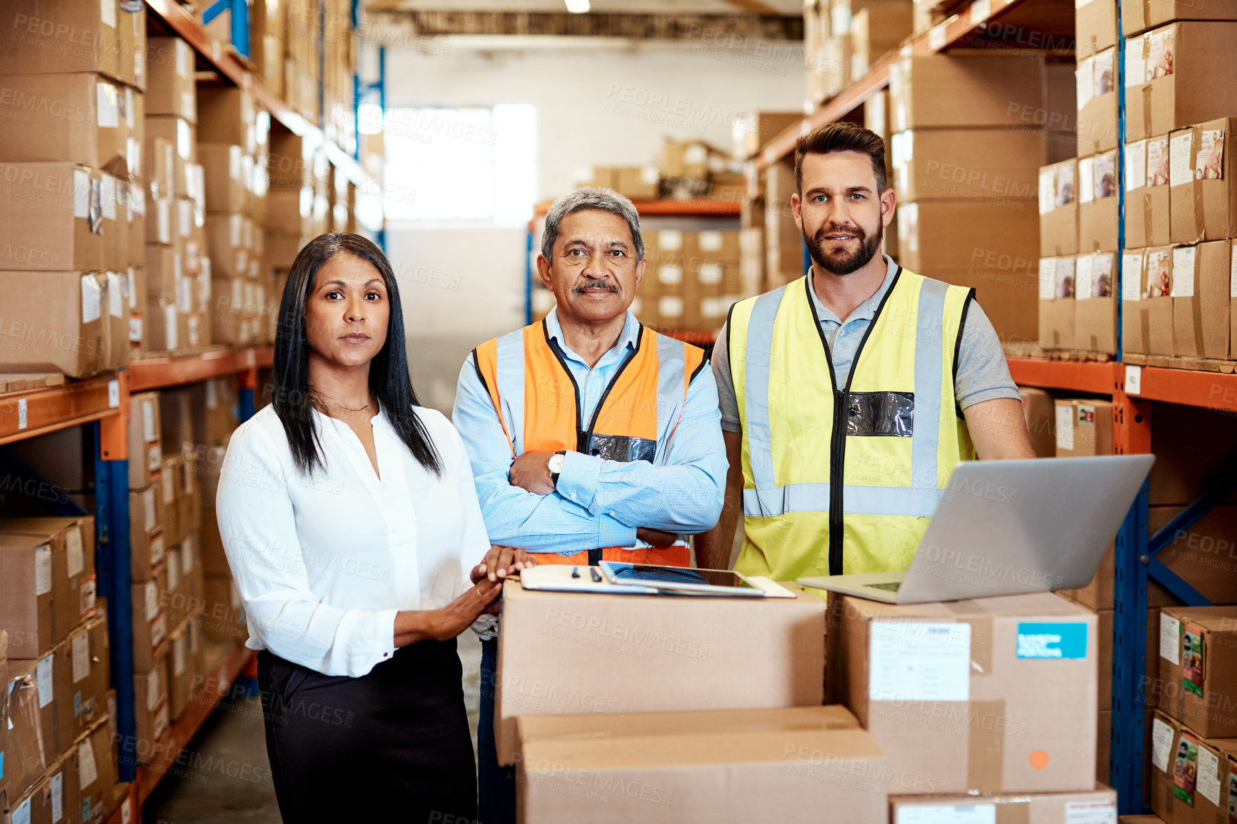 Buy stock photo Cropped portrait of three warehouse workers checking on distribution logistics