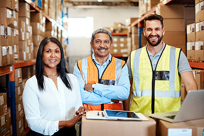Buy stock photo Cropped portrait of three warehouse workers checking on distribution logistics