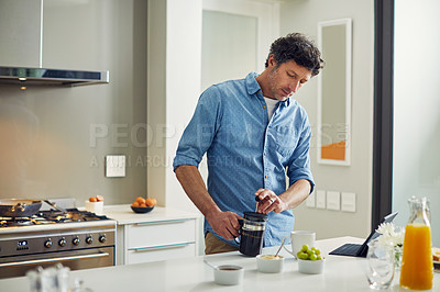 Buy stock photo Shot of a mature couple having coffee in the kitchen at home