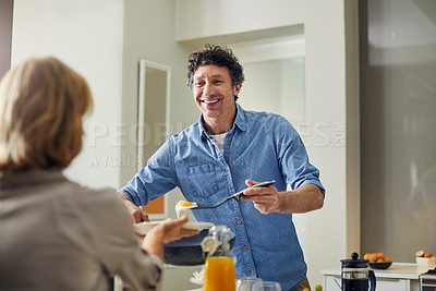 Buy stock photo Shot of a mature man preparing breakfast for him and his wife at home