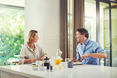 Buy stock photo Shot of a mature couple having a leisurely breakfast together at home