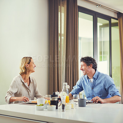 Buy stock photo Shot of a mature couple having a leisurely breakfast together at home