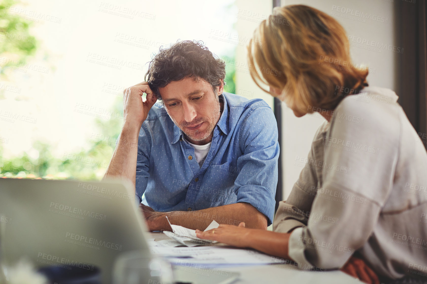 Buy stock photo Shot of a mature couple going over their finances at home