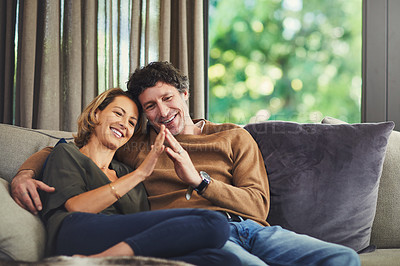 Buy stock photo Shot of an affectionate mature couple relaxing on the sofa at home